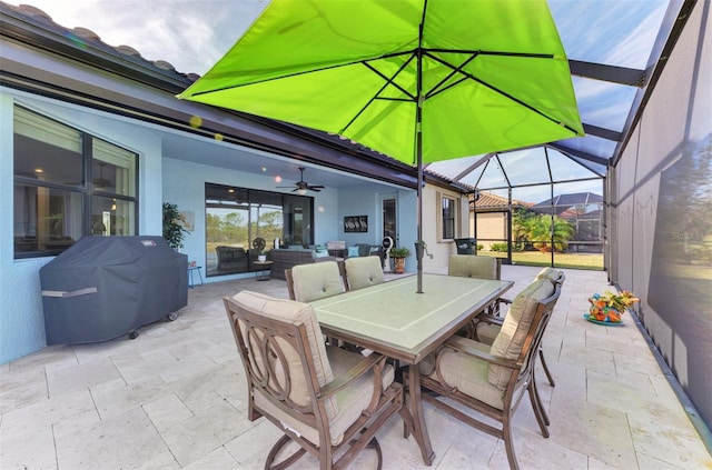 view of patio featuring area for grilling, an outdoor hangout area, glass enclosure, and ceiling fan