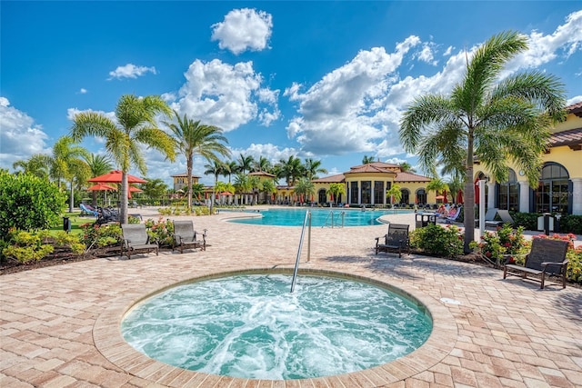 view of pool featuring a community hot tub and a patio