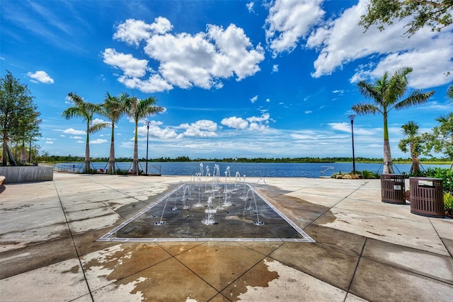 view of patio / terrace with a water view and central air condition unit