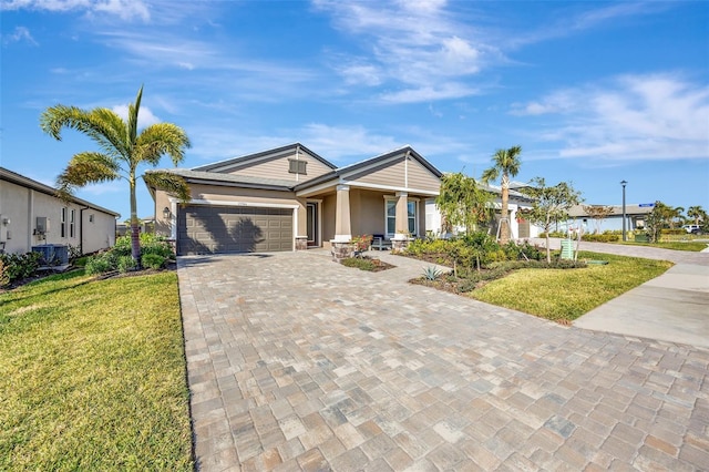 ranch-style house featuring central AC unit, a garage, and a front lawn