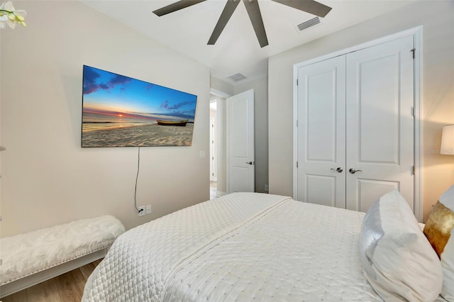 bedroom with ceiling fan, a closet, and wood-type flooring