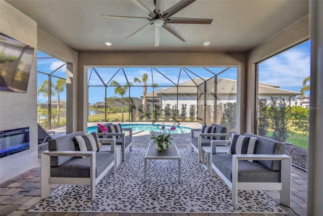 view of patio / terrace with ceiling fan, an outdoor hangout area, and glass enclosure