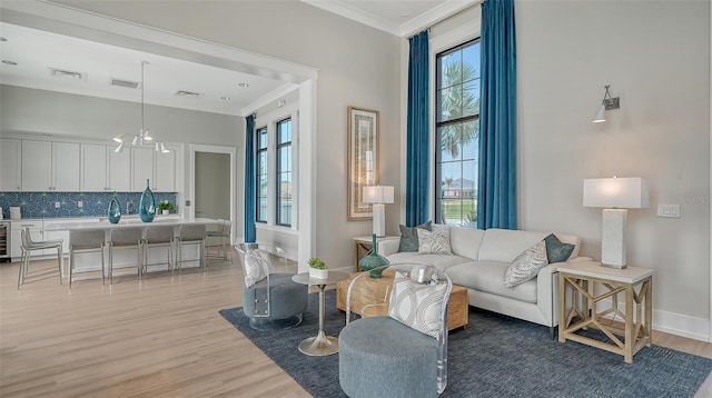 17744 Savory Mist Cir, Bradenton, FL 34211 - living area featuring crown molding, baseboards, light wood finished floors, and plenty of natural light