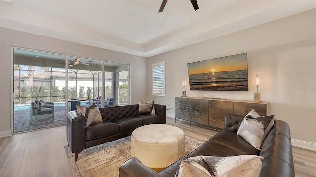 17744 Savory Mist Cir, Bradenton, FL 34211 - living area featuring a sunroom, ceiling fan, and baseboards