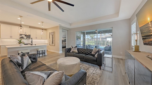 17744 Savory Mist Cir, Bradenton, FL 34211 - living room featuring a healthy amount of sunlight, baseboards, and a ceiling fan