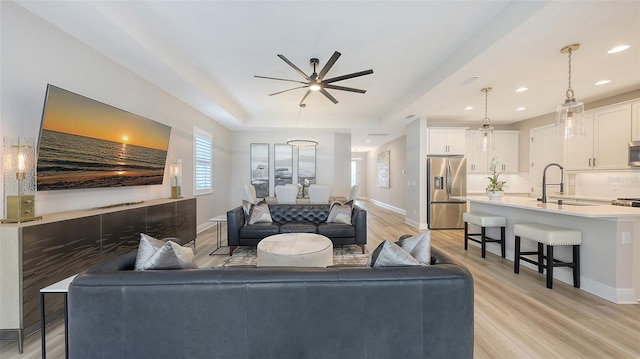 17744 Savory Mist Cir, Bradenton, FL 34211 - living area featuring light wood-style floors, baseboards, and a ceiling fan