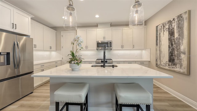 17744 Savory Mist Cir, Bradenton, FL 34211 - kitchen featuring stainless steel appliances, light countertops, a sink, and backsplash
