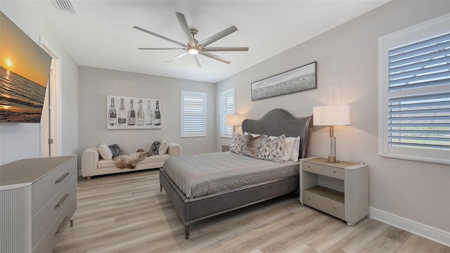 17744 Savory Mist Cir, Bradenton, FL 34211 - bedroom featuring light wood finished floors, visible vents, multiple windows, and baseboards