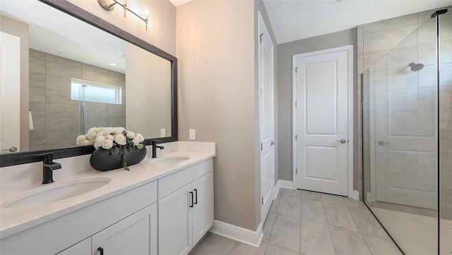 17744 Savory Mist Cir, Bradenton, FL 34211 - bathroom with tile patterned floors, a tile shower, baseboards, and a sink