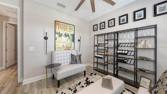17744 Savory Mist Cir, Bradenton, FL 34211 - living area featuring wood finished floors, baseboards, a ceiling fan, and visible vents