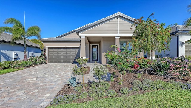 17744 Savory Mist Cir, Bradenton, FL 34211 - view of front facade featuring decorative driveway, a garage, and stucco siding