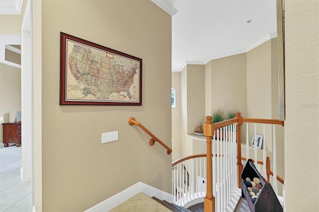 stairs with tile patterned floors and ornamental molding