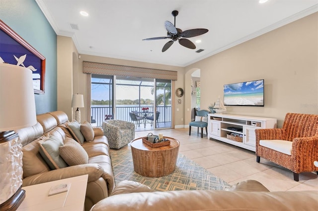 living room featuring ornamental molding, light tile patterned floors, and ceiling fan