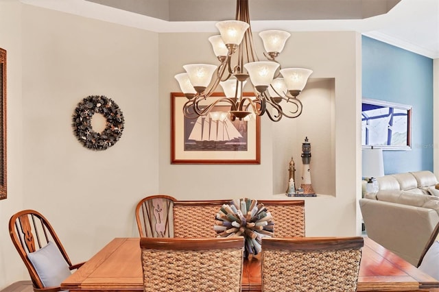 dining room with a notable chandelier and ornamental molding