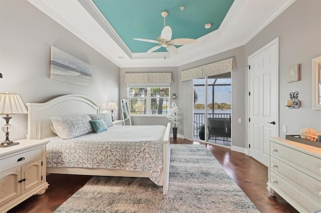 bedroom with crown molding, ceiling fan, dark hardwood / wood-style floors, access to outside, and a raised ceiling