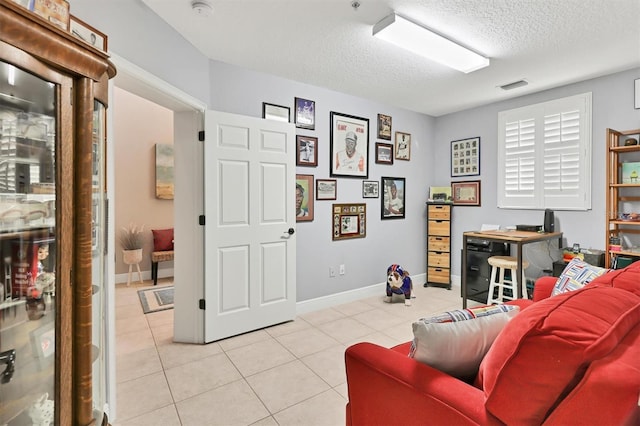 tiled living room featuring a textured ceiling