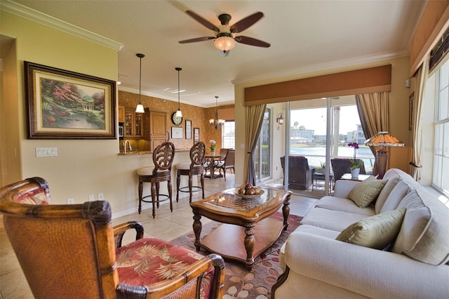 tiled living room featuring ceiling fan with notable chandelier and crown molding