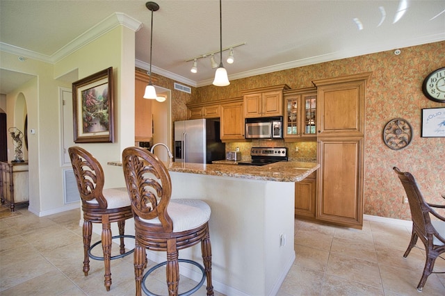 kitchen featuring light stone countertops, hanging light fixtures, stainless steel appliances, crown molding, and a textured ceiling