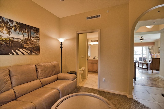 living room with ceiling fan and light tile patterned floors