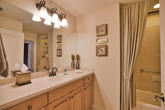 bathroom featuring vanity and shower / tub combo