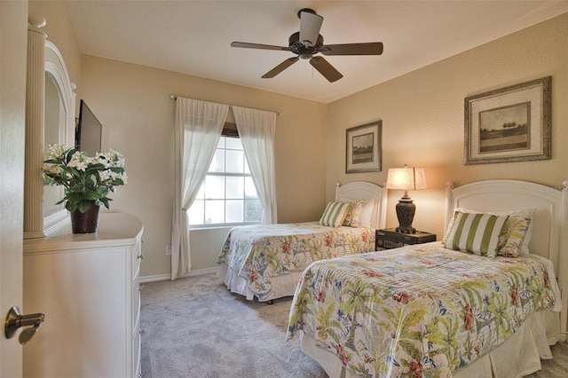 bedroom with light carpet and ceiling fan