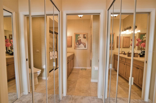 bathroom featuring tile patterned flooring, vanity, and toilet