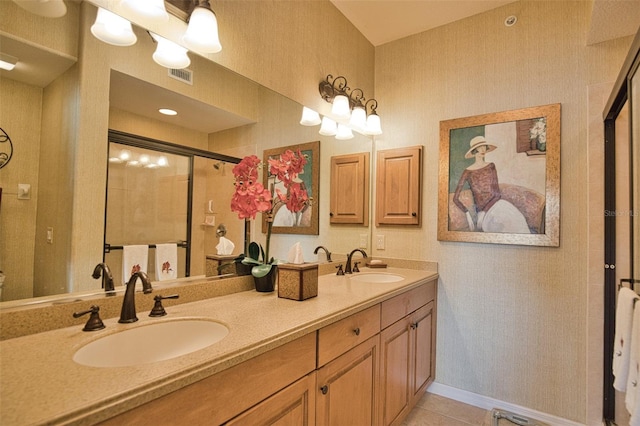 bathroom with tile patterned floors, vanity, and walk in shower