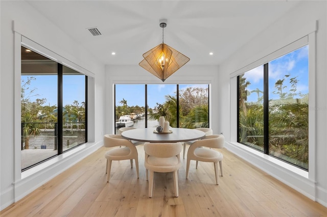 sunroom / solarium featuring an inviting chandelier and plenty of natural light