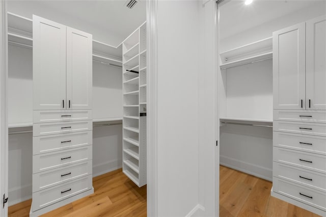 spacious closet with light hardwood / wood-style floors