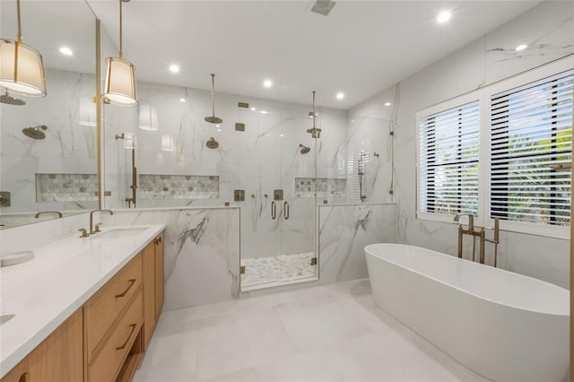 bathroom featuring vanity, independent shower and bath, and tile walls