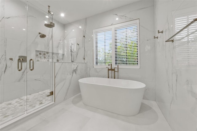 bathroom featuring tile walls and independent shower and bath