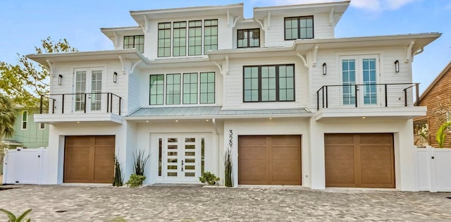 view of front of property featuring a garage and a balcony