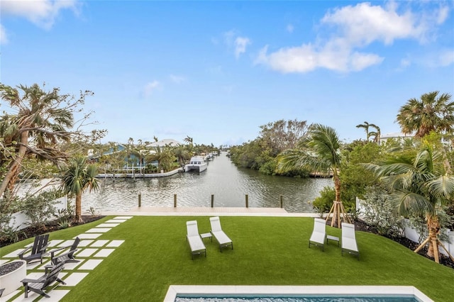 view of property's community with a lawn, a boat dock, and a water view