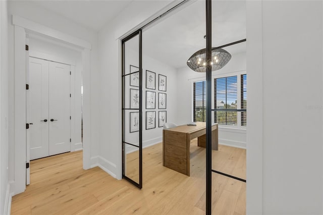 interior space featuring light hardwood / wood-style flooring and an inviting chandelier