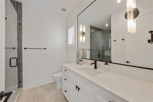 bathroom featuring vanity, toilet, and a shower with door