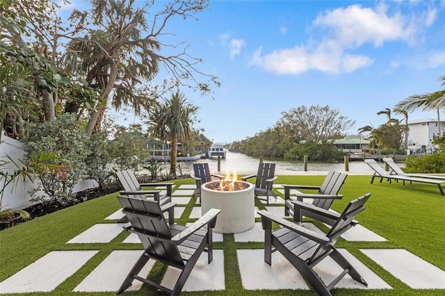 view of patio / terrace with a fire pit and a water view