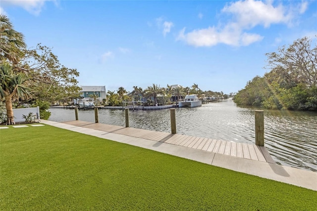 dock area featuring a water view and a lawn