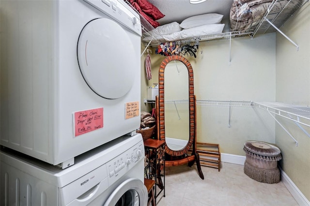 laundry area featuring stacked washer and clothes dryer