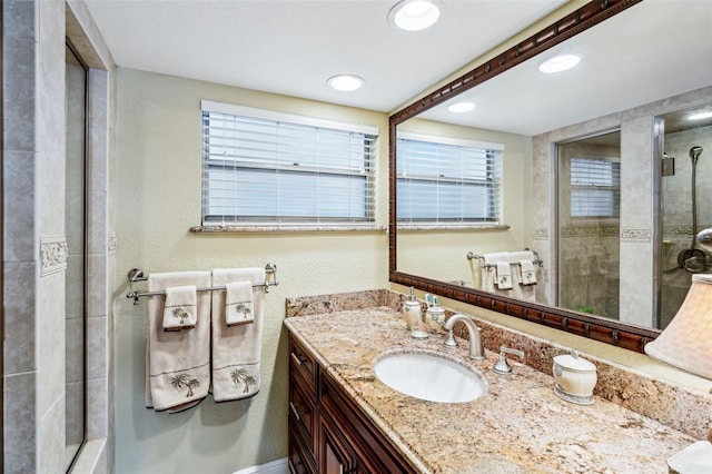 4430 Exeter Dr Unit M108, Longboat Key, FL 34228 - bathroom with vanity, a stall shower, recessed lighting, and a textured wall