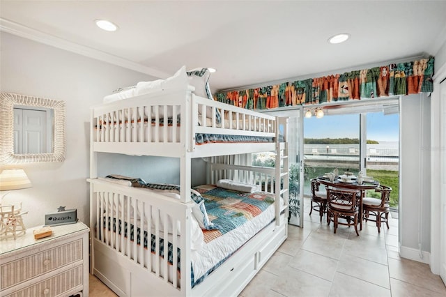 bedroom with light tile patterned floors and crown molding