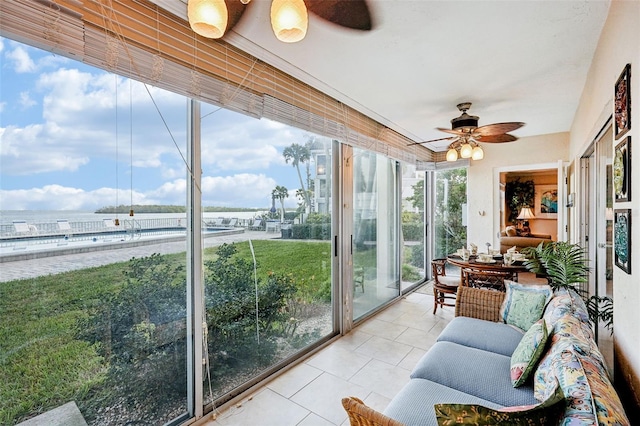 sunroom / solarium featuring ceiling fan