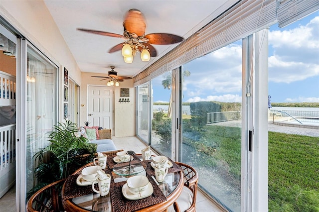 sunroom featuring ceiling fan