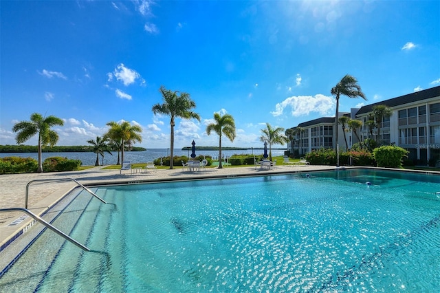 view of pool featuring a water view