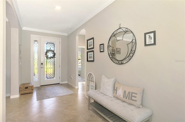 tiled entryway featuring ornamental molding