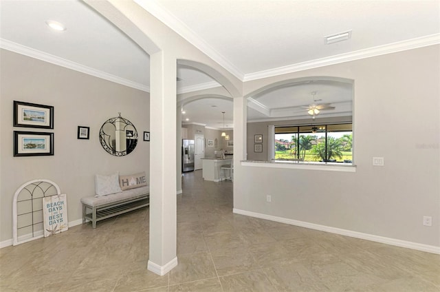 interior space featuring a tray ceiling, light tile patterned floors, and crown molding