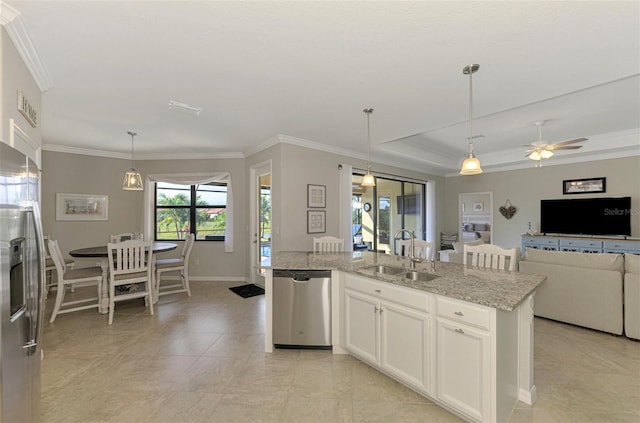 kitchen with pendant lighting, appliances with stainless steel finishes, white cabinetry, sink, and ceiling fan