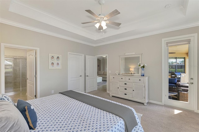 bedroom with ensuite bath, light colored carpet, ceiling fan, and a raised ceiling