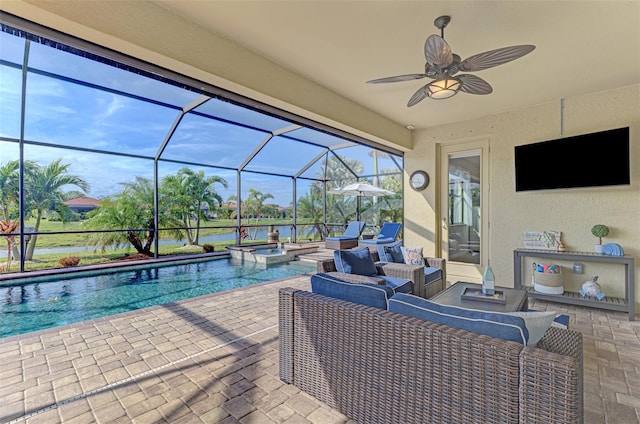 view of pool with a patio area, glass enclosure, an in ground hot tub, ceiling fan, and an outdoor hangout area