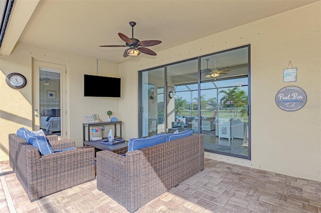 view of patio / terrace featuring glass enclosure, an outdoor hangout area, and ceiling fan