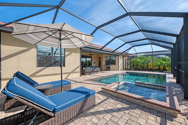 view of pool with glass enclosure, an in ground hot tub, outdoor lounge area, a patio, and ceiling fan